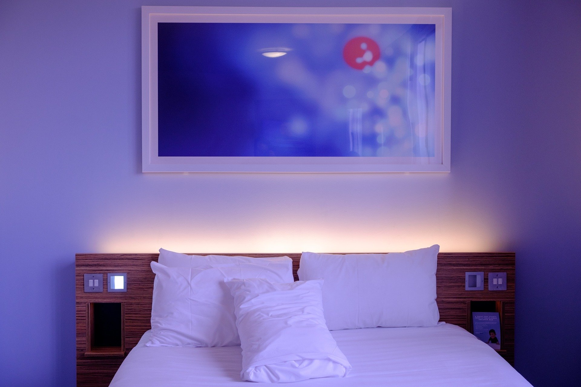 A hotel bedroom with ambient lighting